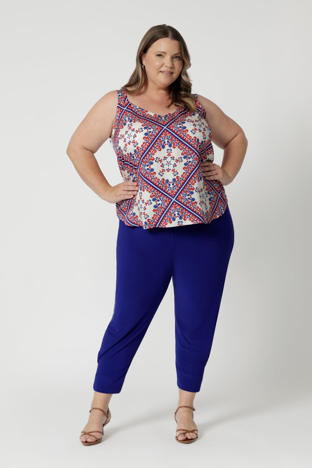 Plus sized model wears summer ready  cami that features wide, comfortable straps, which provide both style, support and aid in the coverage of bra straps. Its clean, simple silhouette gently drapes over the body, creating an elegant and relaxed look. This cami is available in sizes 8-24. 