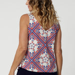 The cami features a soft, draped silhouette that enhances the lightweight nature of the fabric. Both pieces, like the pants, are soft to the touch and designed for ultimate comfort in warm weather.