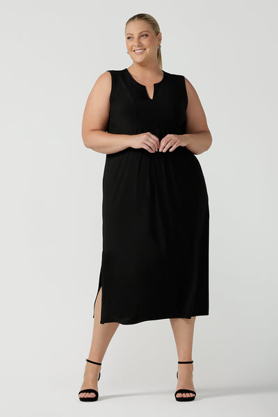 Women's black dress in jersey for women. Pictured on a size 18 for petite to plus size women 8-24. Made in Australia in soft black jersey featuring a v-neckline and pleated front.