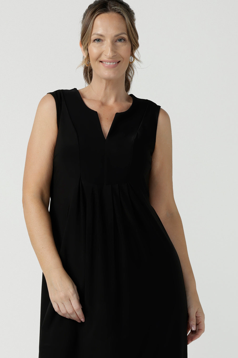 Close up of women's black dress in jersey for women. Pictured on a size 8 for petite to plus size women 8-24. Made in Australia in soft black jersey featuring a v-neckline and pleated front.
