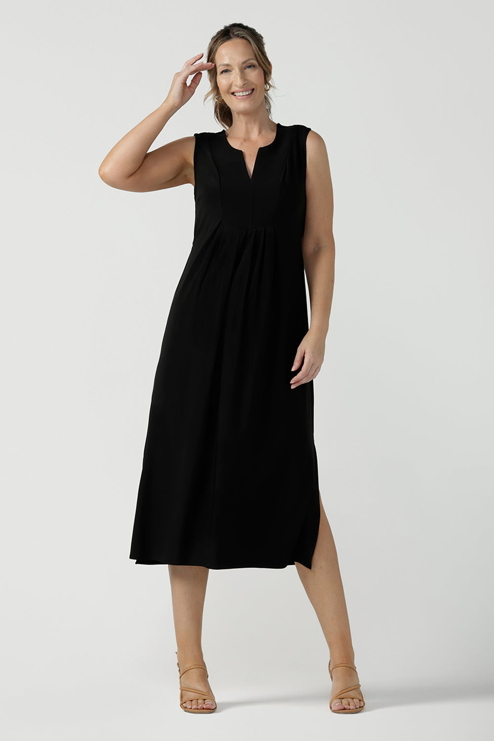 Women's black dress in jersey for women. Pictured on a size 8 for petite to plus size women 8-24. Made in Australia in soft black jersey featuring a v-neckline and pleated front. 