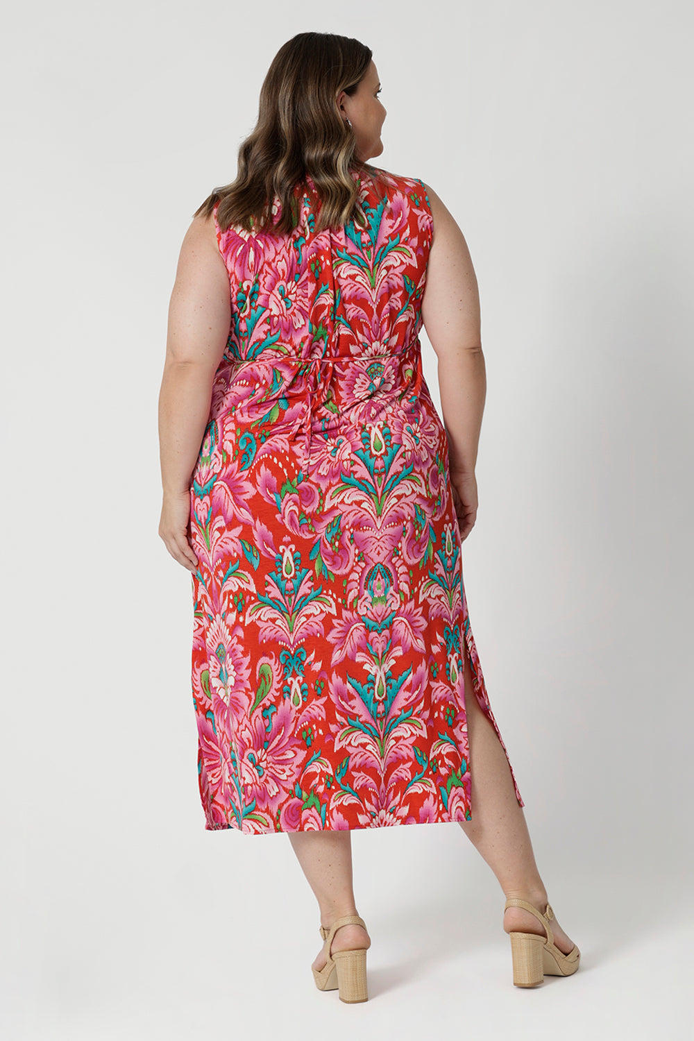 Back view of plus sized model wears lightweight crepe jersey, the dress offers a breathable and soft texture, ensuring comfort even on the warmest days. Leina & Fleur proudly stock petite and plus sizes ranging from 8-24. 