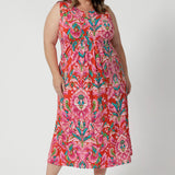 Summer dress worn by size 18 model embodies the essence of a resort lifestyle with summer ready dress. Easy care crepe jersey, its tropical abstract print, evoking a vibrant feel, perfect for resort style and summer vacations. Fabric provides a flattering, flexible fit that moves with you. Shop the Fernanda Dress in Indian Summer in sizes 8-24. 