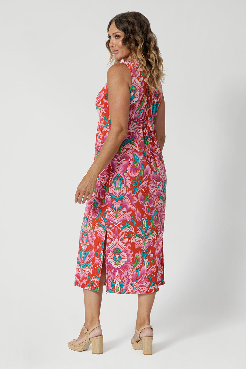 Tropical printed dress worn by over 40 model embodies the essence of a resort lifestyle. The fabric has a slight stretch, providing a flattering, flexible fit that moves with you. Its effortless design and relaxed silhouette make it a versatile addition to your summer wardrobe, ideal for both daytime adventures and evening strolls by the shore. Stocked in sizes 8-24.