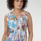 The Fernanda Dress in Limoncello features a sleeveless silhouette with waist ties, pleat detailing, and side splits. This lightweight midi is perfect for summer getaways, evenings, and warm-weather ease.