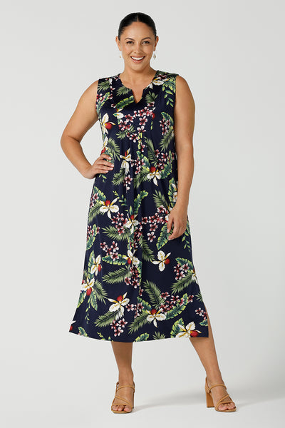 A curvy size 12 woman wears a jersey sleeveless dress with waist tie and v-neckline. The Fernanda dress features the Merriment print, the perfect print for your Christmas event or summer tropical festivities. Made in Australia for woman sizes 8 - 24. 