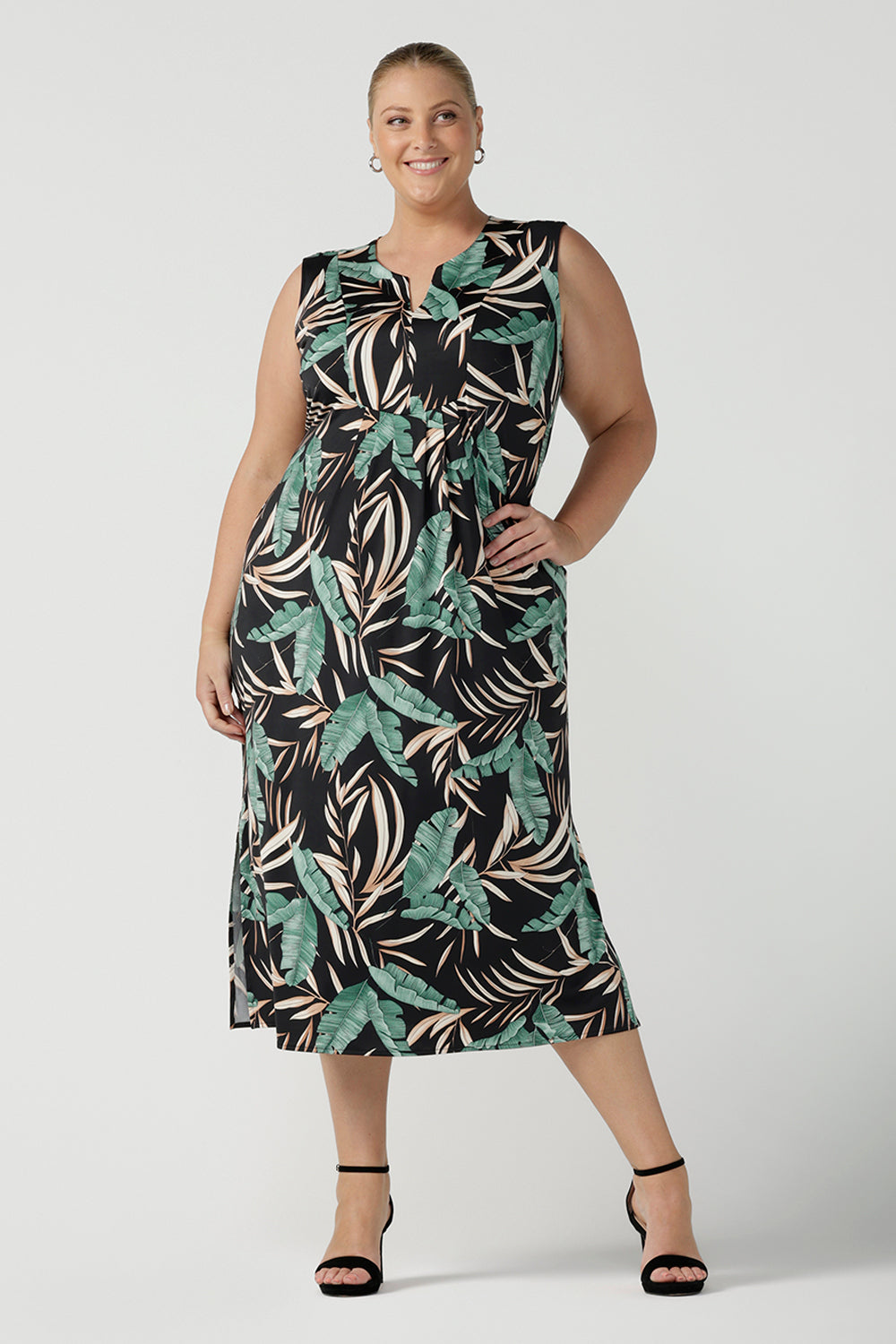 Women's curvy fashion pictured on plus size 18. A Tropical printed dress in a sleeveless design with pleated front and v-neckline. Australian made in size 8 - 24. 