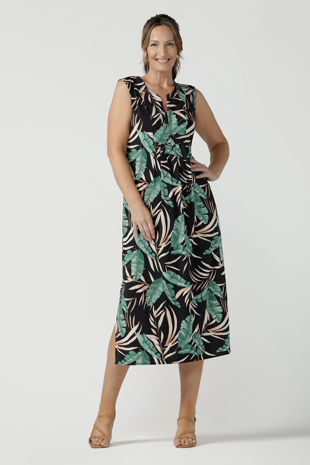 Women's curvy fashion pictured on a size 8. A Tropical printed dress in a sleeveless design with pleated front and v-neckline. Australian made in size 8 - 24. 