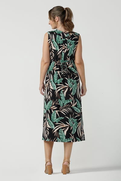 Back view of Women's curvy fashion pictured on a size 8. A Tropical printed dress in a sleeveless design with pleated front and v-neckline. Australian made in size 8 - 24. 