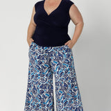 A curvy woman wears the Finely top in Navy paired with printed Dany Culotte. Fixed wrap style perfect for corporate to casual wear. Made in Australia for women size 8 - 24.