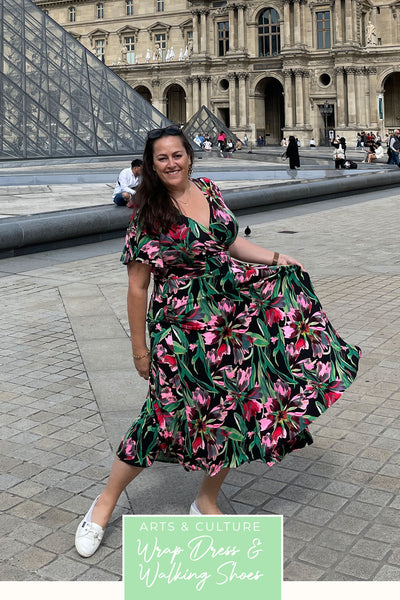 A plus size, curvy woman wears a good wrap dress for travel and holiday wear. With flutter sleeves, this floral print wrap dress pictured at the Louvre in Paris, is made in Australia by women's fashion brand, Leina & Fleur.