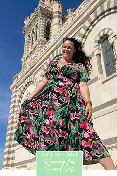 A plus size, curvy woman wears a good wrap dress for travel and holiday wear. With flutter sleeves, this floral print wrap dress is made in Australia by women's clothing brand, Leina & Fleur.