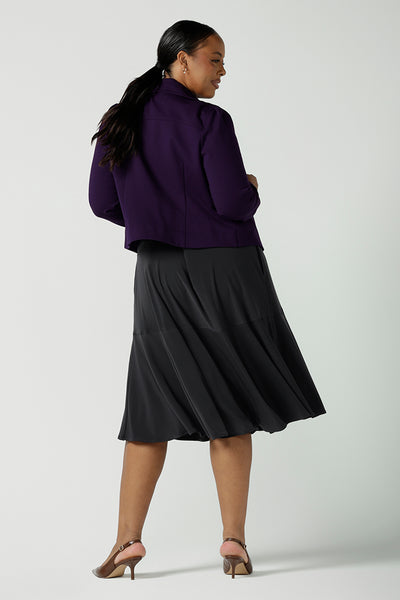 Back view of a size 16 woman wears the Garcia Jacket in Alpine. A Amethyst jacket made in Australia for women. Size 8 - 24. Styled back with a floral Vida top and charcoal berit skirt. Comfortable and Stylish workwear for ladies.