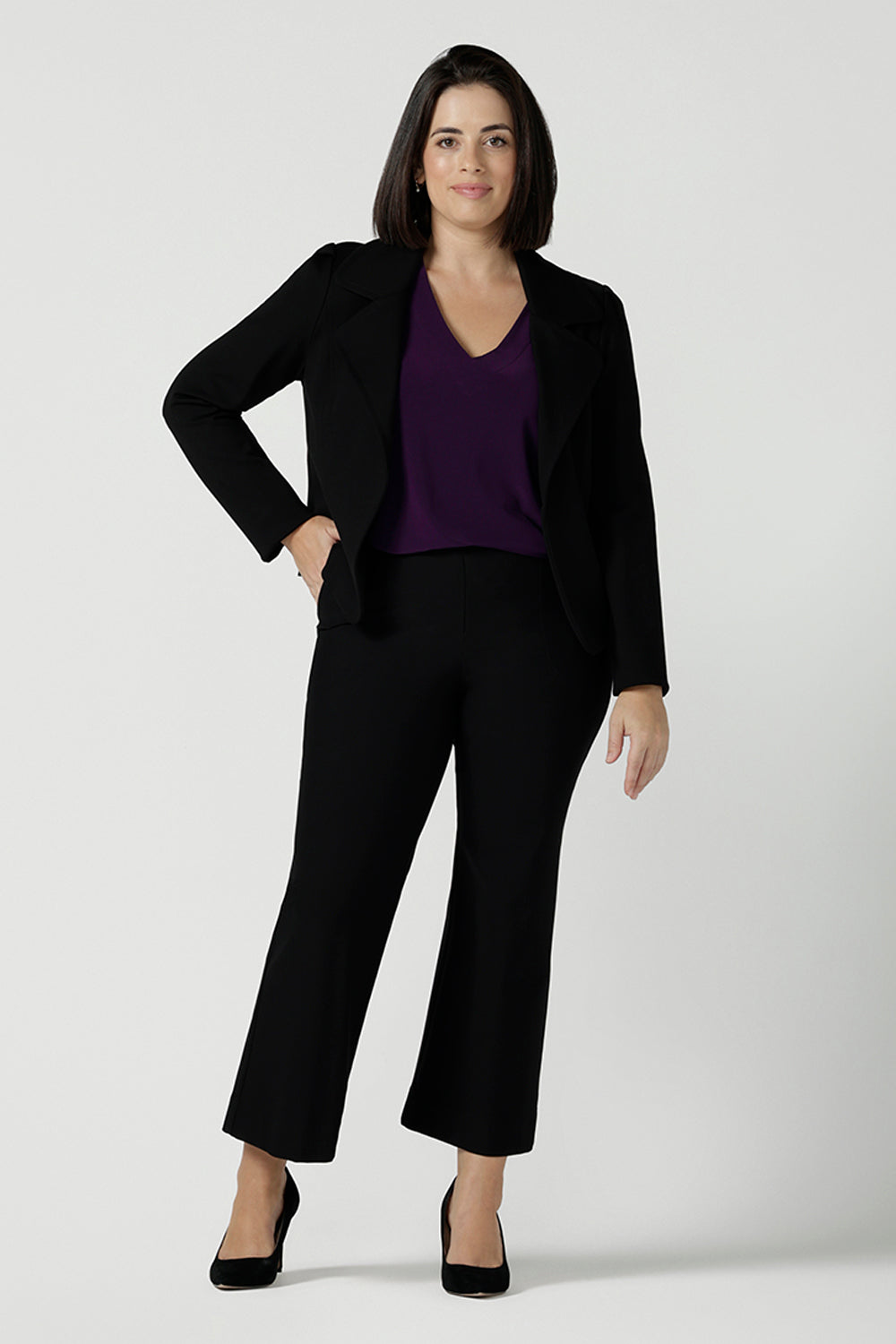 Size 10 woman wears the Garcia Jacket in Black. Tailored design with collar and comfortable stretch. Comfortable and stylish workwear for women. Size inclusive fashion and made in Australia for women size 8 - 24.