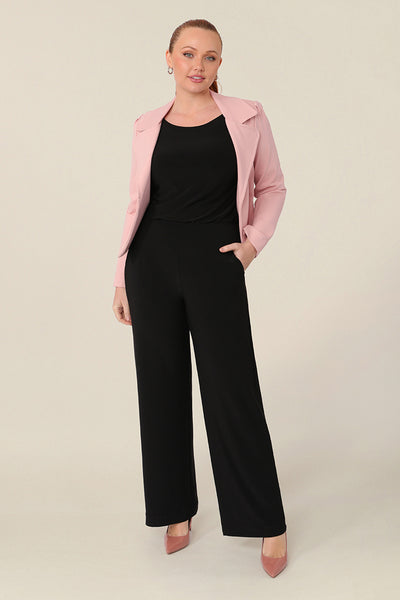 A size 12 curvy woman wears a tailored jacket with open front and collar and notch lapels is made in Blush pink ponte fabric. Shop exclusive luxury, this work jacket is available to pre-order at Australian and New Zealand women's clothing label, L&F.