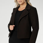 Its contemporary design features a clean front with double-layered tailored panels, complemented by refined collar and notch lapels with subtle topstitch detailing for a polished finish. A shoulder yoke and back darts enhance the fit, while full-length sleeves with gentle tucks at the sleeve heads add a touch of softness to the overall look.