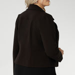 Its contemporary design features a clean front with double-layered tailored panels, complemented by refined collar and notch lapels with subtle topstitch detailing for a polished finish. A shoulder yoke and back darts enhance the fit, while full-length sleeves with gentle tucks at the sleeve heads add a touch of softness to the overall look.