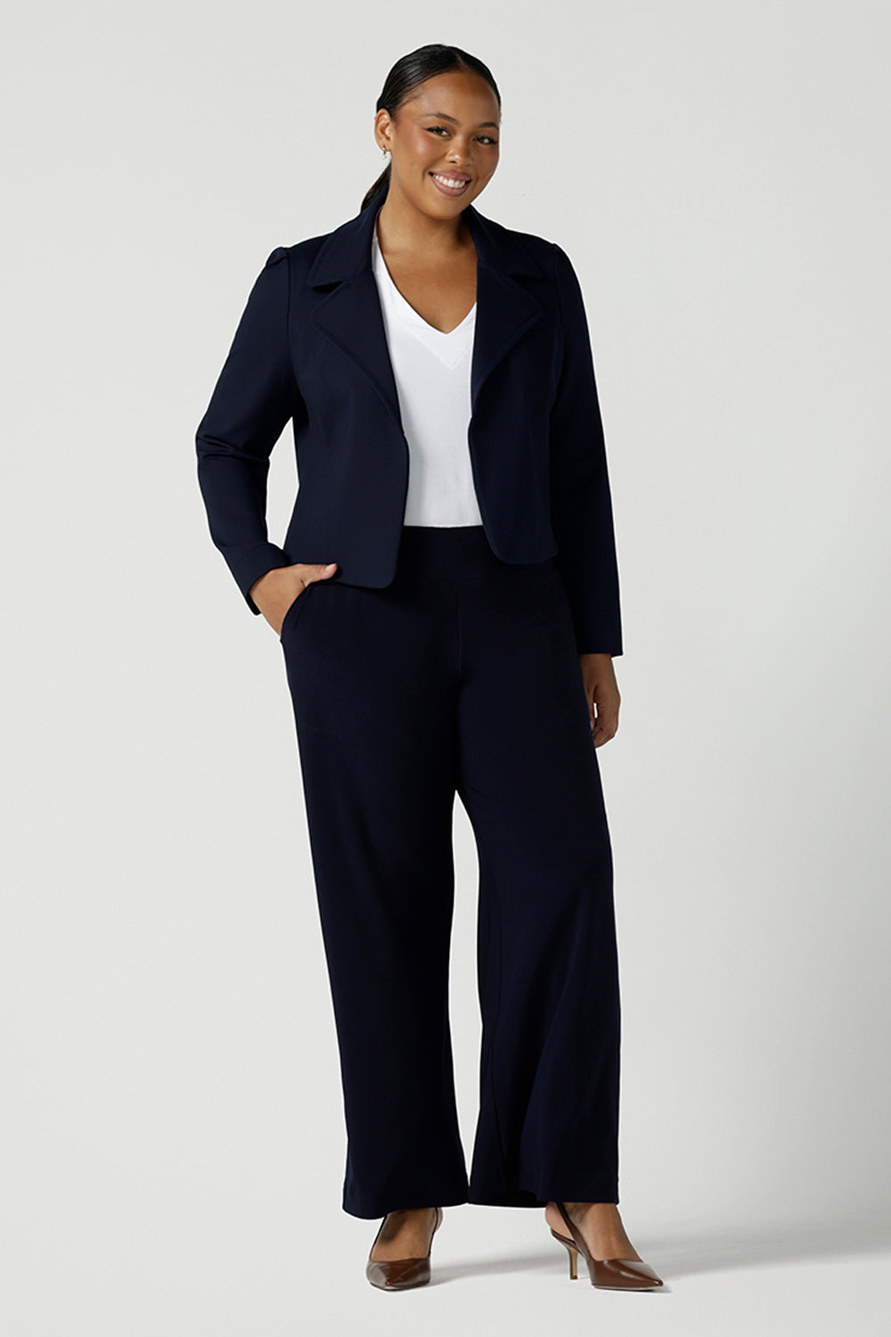 Size 16 woman wears the Garcia Jacket in Navy. Stylish comfortable workwear for women. Tailored with dry touch tech stretch jersey. Made in Australia size 8 - 24.