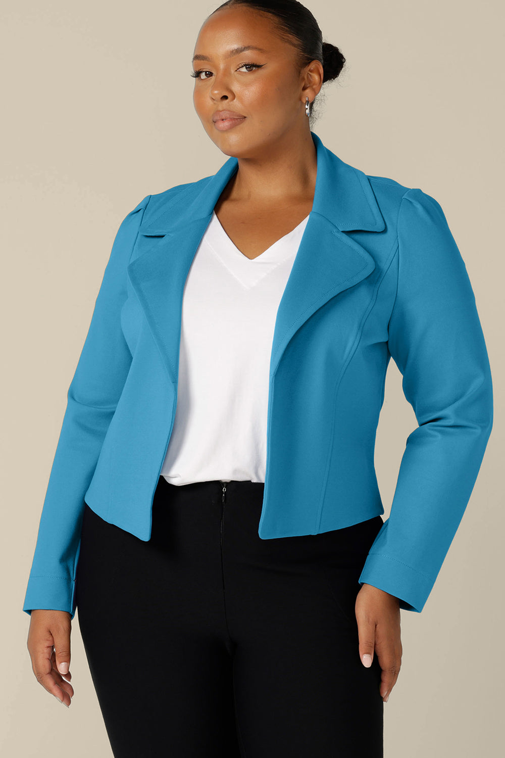 A size 18, fuller figure woman wears the Garcia Jacket in Opal blue ponte fabric by Australian and New Zealand women's clothing brand, L&F. Featuring collar and notch lapels and long sleeves, this open-fronted jacket is good for corporate wear and casual wear.