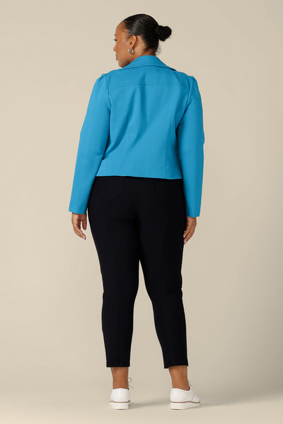 Back view of a size 18, fuller figure woman wearing the Garcia Jacket in Opal blue ponte fabric by Australian and New Zealand women's clothing brand, L&F. Featuring collar and notch lapels and long sleeves, this open-fronted jacket is good for workwear and casual wear.
