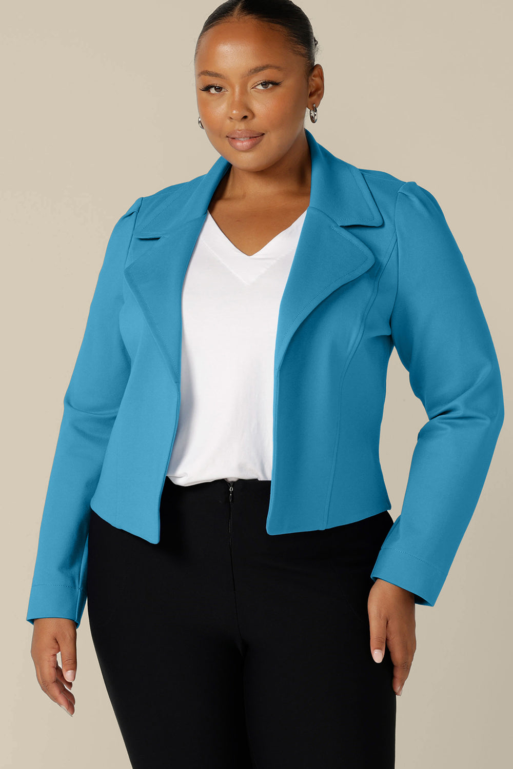 Made in Australia by Australian and New Zealand women's clothing label, L&F, this is the Garcia Jacket in Opal, made from stretch ponte fabric. Open-fronted and tailored to fit, this good work wear jacket is available to buy in sizes 8 to 24.A size 18, plus size woman wears the Garcia Jacket in Opal blue ponte fabric by Australian and New Zealand women's clothing label, L&F. Featuring collar and notch lapels and long sleeves, this open-fronted jacket is available in an inclusive size range of sizes 8 to 24.