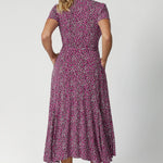 Back view image of size 12 model wears printed wrap dress. Full body stretch provided by the easy care fabric, offering a comfortable fit for a wide range of shapes and sizes. Woman's clothing brand Leina & Fleur offer sizes 8 to 24. 