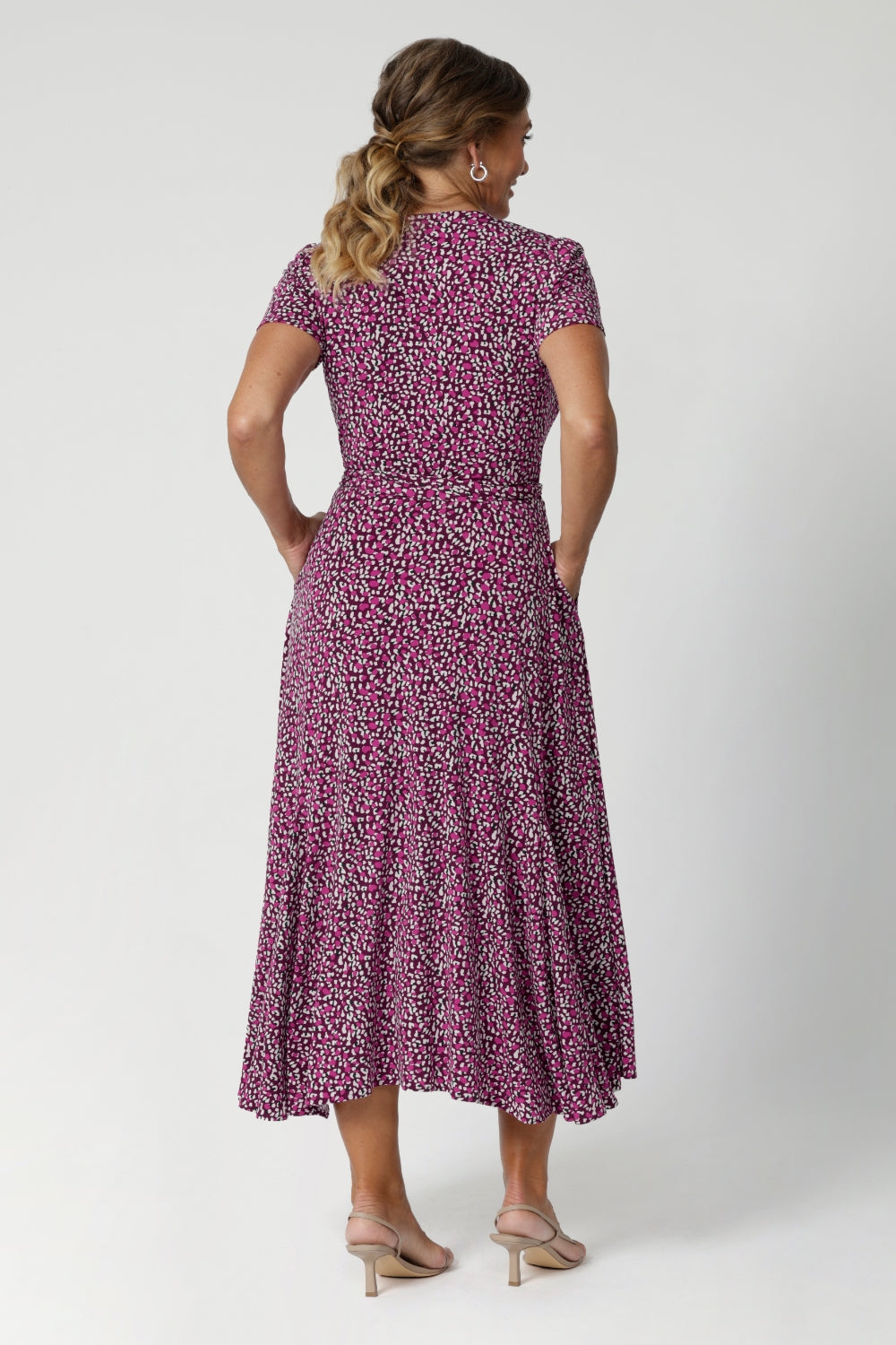 Back view image of size 12 model wears printed wrap dress. Full body stretch provided by the easy care fabric, offering a comfortable fit for a wide range of shapes and sizes. Woman's clothing brand Leina & Fleur offer sizes 8 to 24. 