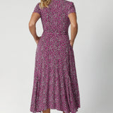 Back view image of size 12 model wears printed wrap dress. Full body stretch provided by the easy care fabric, offering a comfortable fit for a wide range of shapes and sizes. Woman's clothing brand Leina & Fleur offer sizes 8 to 24. 