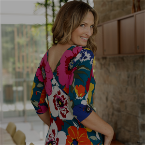 a woman wears a reversible wrap dress with 3/4 sleeves by Australian-made luxury fashion brand, Leina & Fleur.
