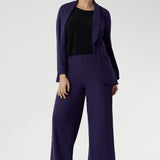 Crafted from our signature dry-touch stretch jersey, this everyday piece features a chic boat neckline and a sleek, streamlined silhouette that layers beautifully. Size 10 model wears her reversible cami under full purple suit for a powerful workwear look. 