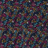 Close up swatch image of Harmony print, which features a navy dry-touch jersey base adorned with floral details in rich hues of magenta, mustard, blue, and vanilla. Used to create garments for a summer corporate wardrobe in sizes 8-24.