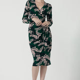 A size 10 model wears the Alpine Fern Heather dress in jersey. Made in Australia for women size 8 - 24. Fern green with leaf print all over.