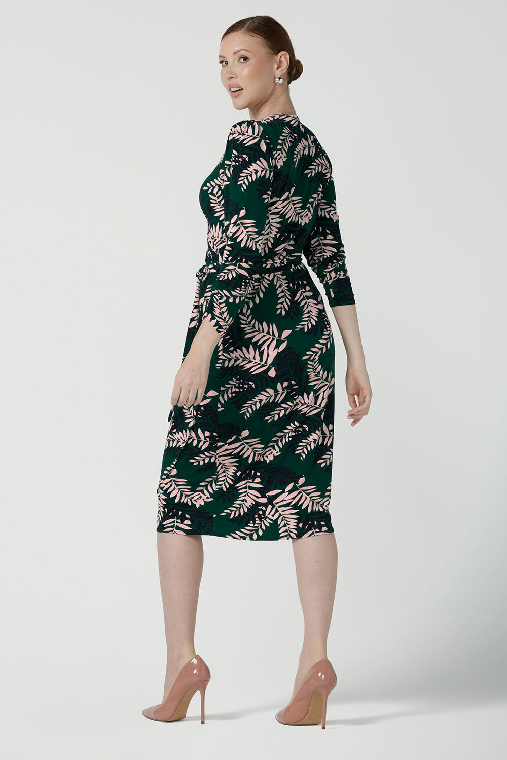 Back view of A size 10 model wears the Alpine Fern Heather dress in jersey. Made in Australia for women size 8 - 24. Fern green with leaf print all over.