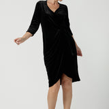 Size 10 model wears the Hedy dress in Black. A velour functioning wrap dress with a tulip skirt and draped front. Up Late evening wear for event dressing. Size inclusive sustainable fashion made in Australia size 8 - 24.