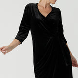 Close up a size 10 model wears the Hedy dress in Black. A velour functioning wrap dress with a tulip skirt and draped front. Up Late evening wear for event dressing. Size inclusive sustainable fashion made in Australia size 8 - 24.