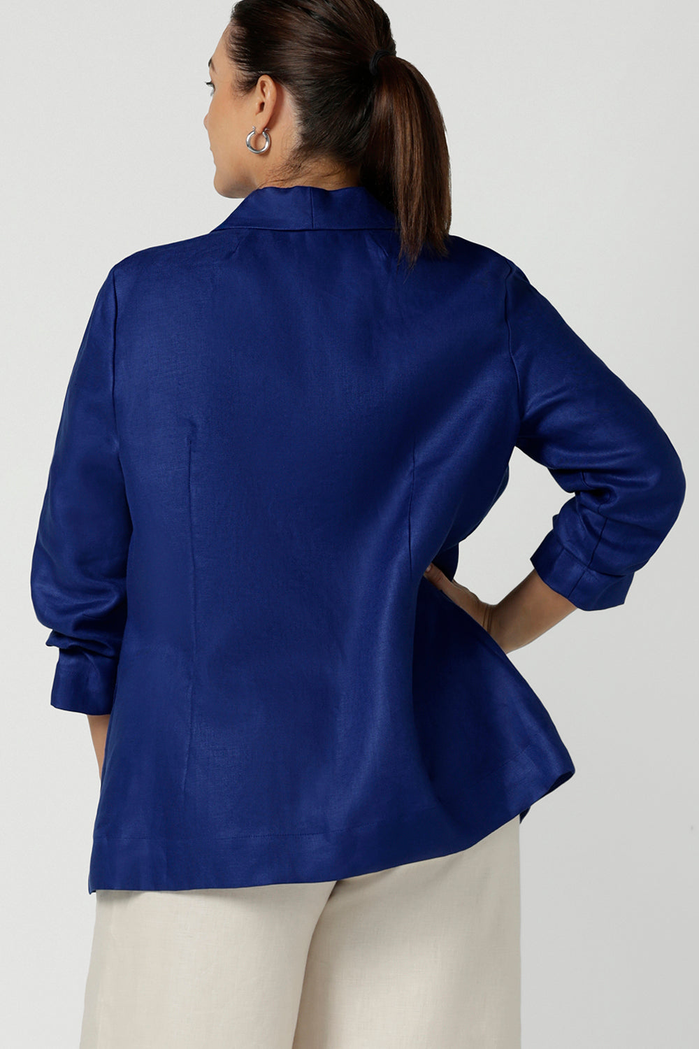 Back view of a Houston Blazer in Cobalt Linen. Softly tailored in Linen with front pockets and a functioning button front. Made in Australia for women size 8 - 24. Styled back with Nik Pants in Parchment Linen and a Cobalt Eddy cami top.