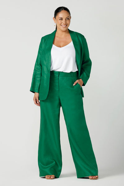 A size 12 curvy woman wears an emerald green tailored linen pant. Styled back with a matching emerald linen blazer. A great work to event look. Made in Australia sizes 8- 24.