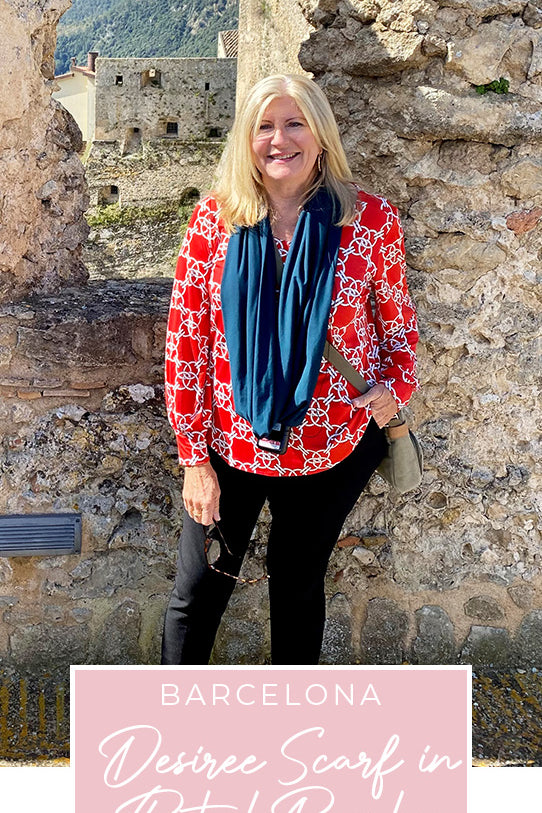 Loyal customer of Australian and New Zealand women's clothing label, L&F, Susan wears a printed jersey, top in red and white print with slim-leg black pants and green bamboo jersey scarf on holiday in Spain, as part of her guide on what clothes to pack for the ultimate capsule travel wardrobe..