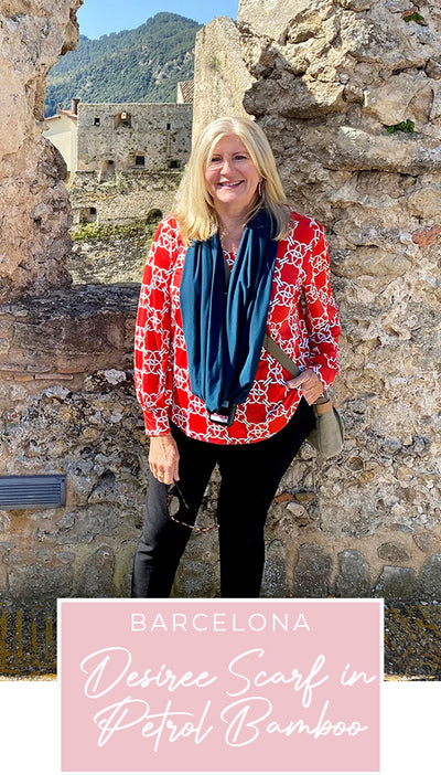 Loyal customer of Australian and New Zealand women's clothing label, L&F, Susan wears a printed jersey, top in red and white print with slim-leg black pants and green bamboo jersey scarf on holiday in Spain, as part of her guide on what clothes to pack for the ultimate capsule travel wardrobe..