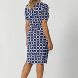 A centre-back tailored tuck enhances the fit, adding structure and a flattering silhouette. The dress also features subtle stretch at the waist, creating a smooth, defined shape that flatters your figure. Model in images wears printed dress with brown kitten heels and silver accessories.