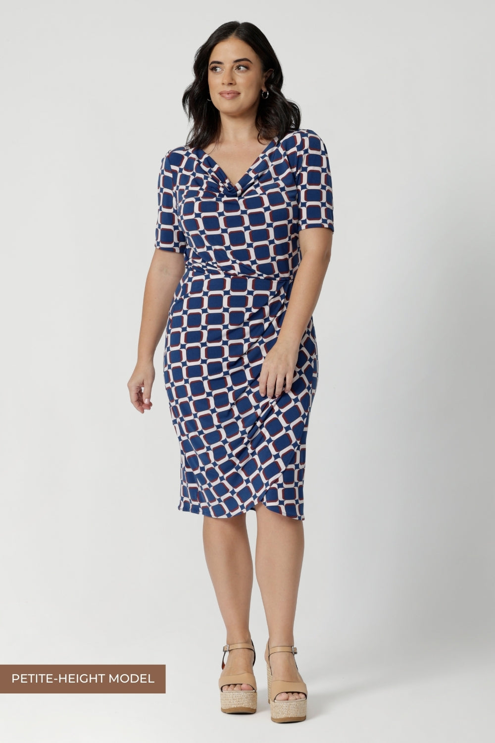 Whether you’re attending meetings, working from the office, or dressing for a business event, this dress will keep you looking chic and confident. Designed for women’s professional fashion, the Imelda Dress is your go-to for effortless style and comfort. Petite height model wears knee length workwear dress paired with platform wedges, creating an elevated outing or workwear look.