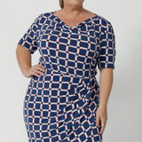 The cowl neckline adds a touch of sophistication and elegance to the design, while the elbow-length sleeves with tuck details at the shoulder provide a unique, refined look. Knee length dress also features subtle stretch at the waist, creating a smooth, defined shape that flatters your figure. Plus size model wears the Imelda Dress in a size 18.