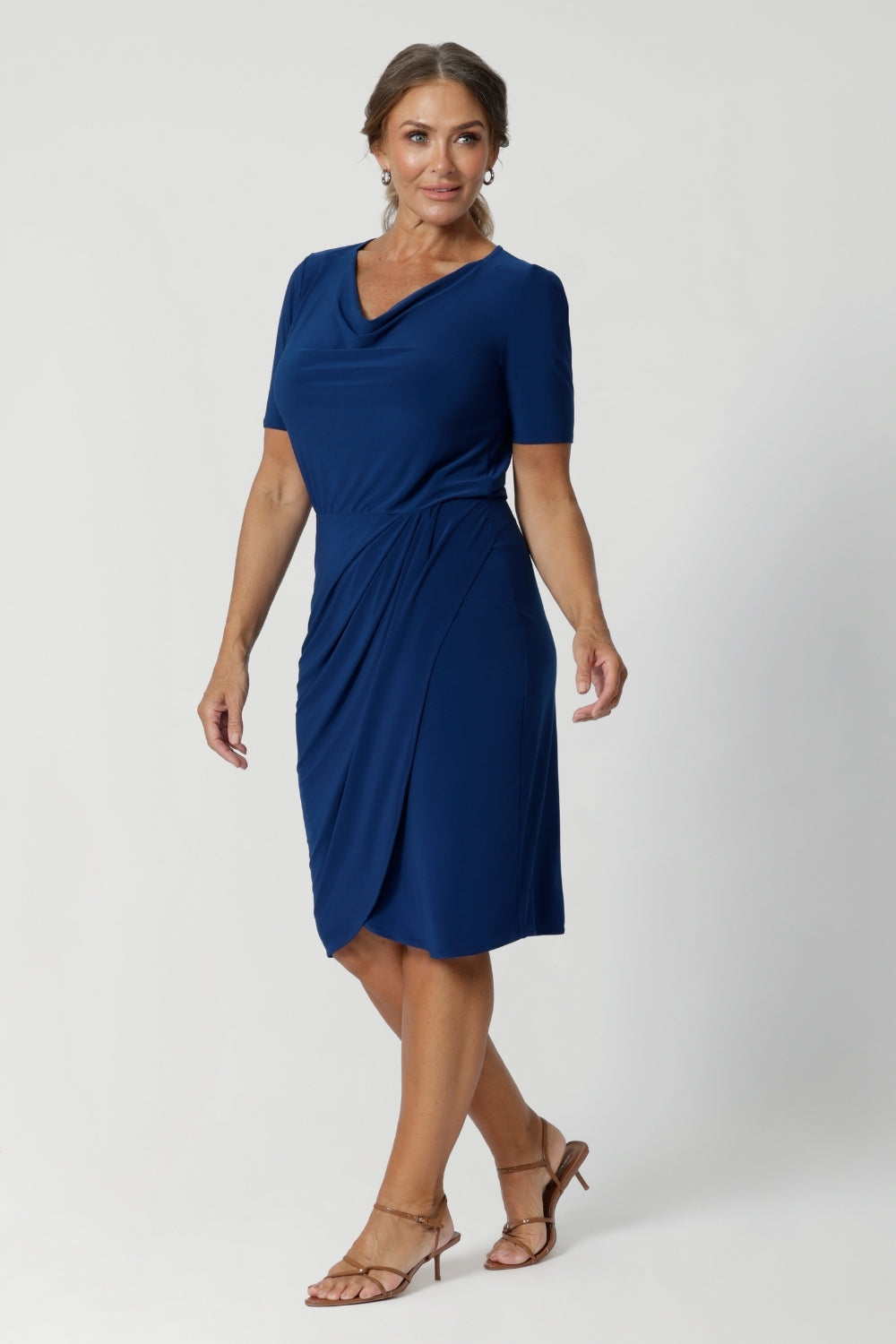 Crafted from a deep blue dry-touch jersey fabric, the dress features a soft stretch that moves with you, ensuring all-day comfort without sacrificing style. Imelda is on a deep blue dry touch jersey base. Fabric has a soft stretch. 