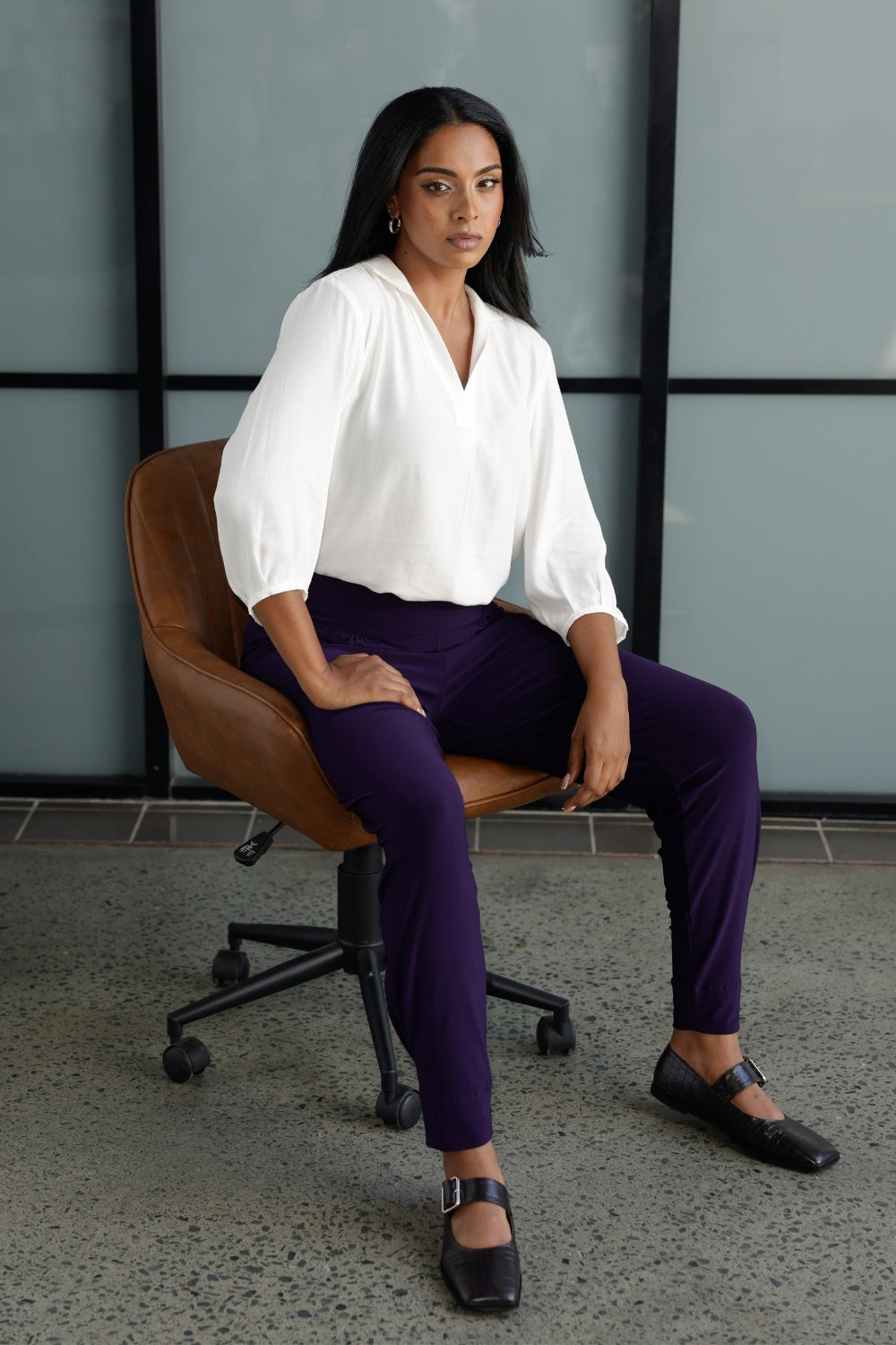 A size 10 Indi pant in Amethyst in a jersey workwear pant with pleat front and cuffed leg opening. Made in Australia for women size 8-24. Styled back with the Arley Shirt in Vanilla. 