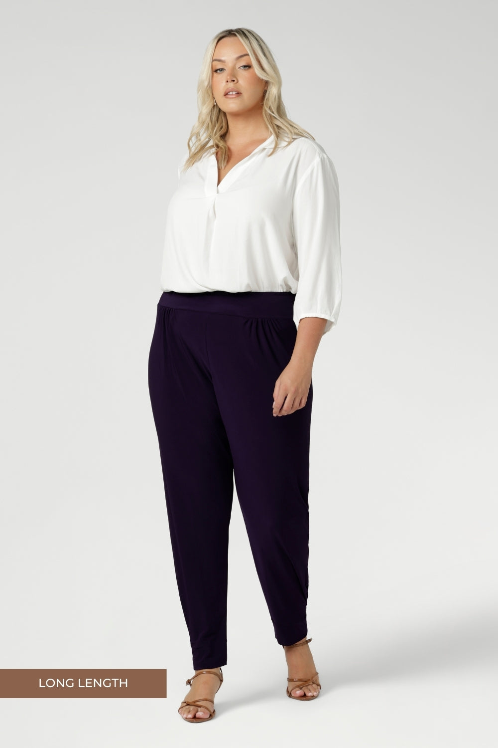 Plus size woman wears stretchy travel pants made from dry touch jersey fabric. Workwear pant have a pleat front and cuffed leg opening. Made in Australia for women size 8-2 4 and now available in 2 lengths.