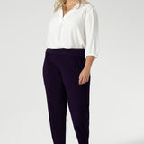 Plus size woman wears stretchy travel pants made from dry touch jersey fabric. Workwear pant have a pleat front and cuffed leg opening. Made in Australia for women size 8-2 4 and now available in 2 lengths.