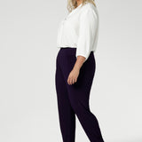 Made in Australia for women size 8-2 4 and now available in 2 lengths. Plus size woman wears stretchy travel pants made from dry touch jersey fabric. Workwear pant have a pleat front and cuffed leg opening. 