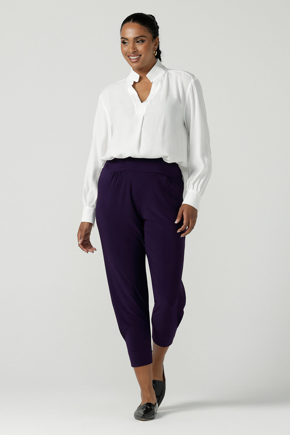 A size 10 Indi pant in Amethyst in a jersey workwear pant with pleat front and cuffed leg opening. Made in Australia for women size 8-24.  Styled back with the Ellis Shirt in Vanilla. 