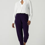 A size 10 Indi pant in Amethyst in a jersey workwear pant with pleat front and cuffed leg opening. Made in Australia for women size 8-24.  Styled back with the Ellis Shirt in Vanilla. 