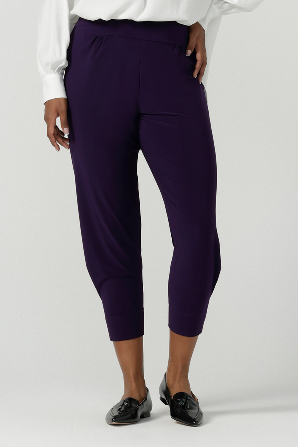 Close up of a size 10 Indi pant in Amethyst in a jersey workwear pant with pleat front and cuffed leg opening. Made in Australia for women size 8-24. Styled back with the Ellis Shirt in Vanilla.